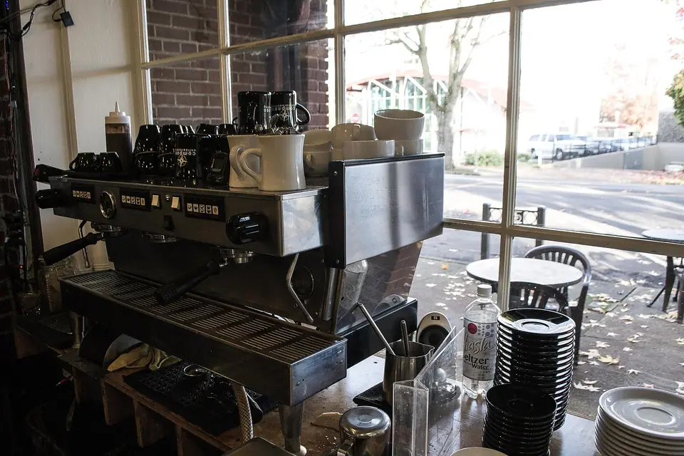 Café espresso machine beside a window
