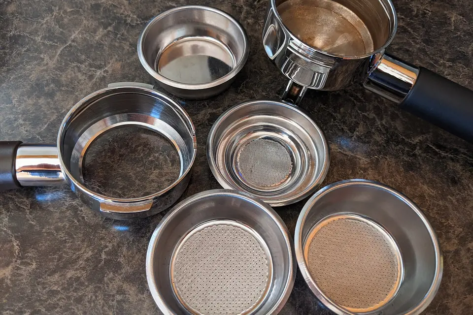 Espresso portafilters and filter baskets on a counter