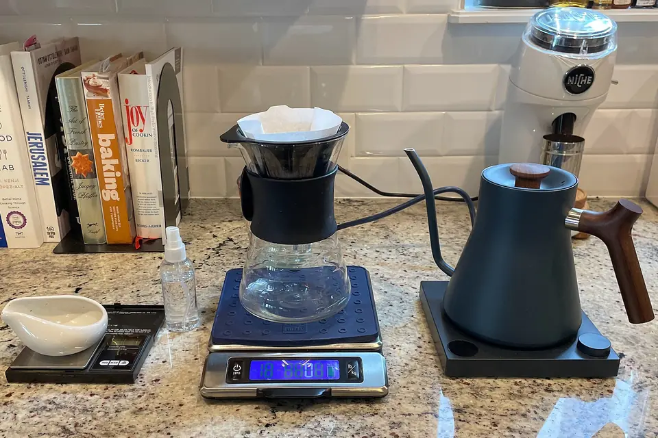 Pour-over brewer and kettle on kitchen scales