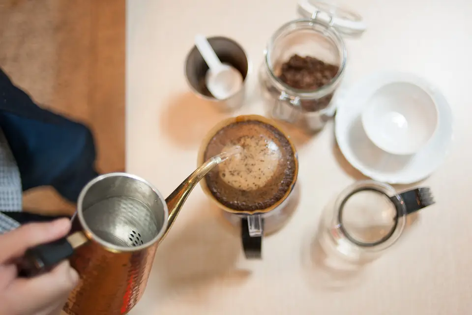 Pouring water over coffee in a pour-over dripper